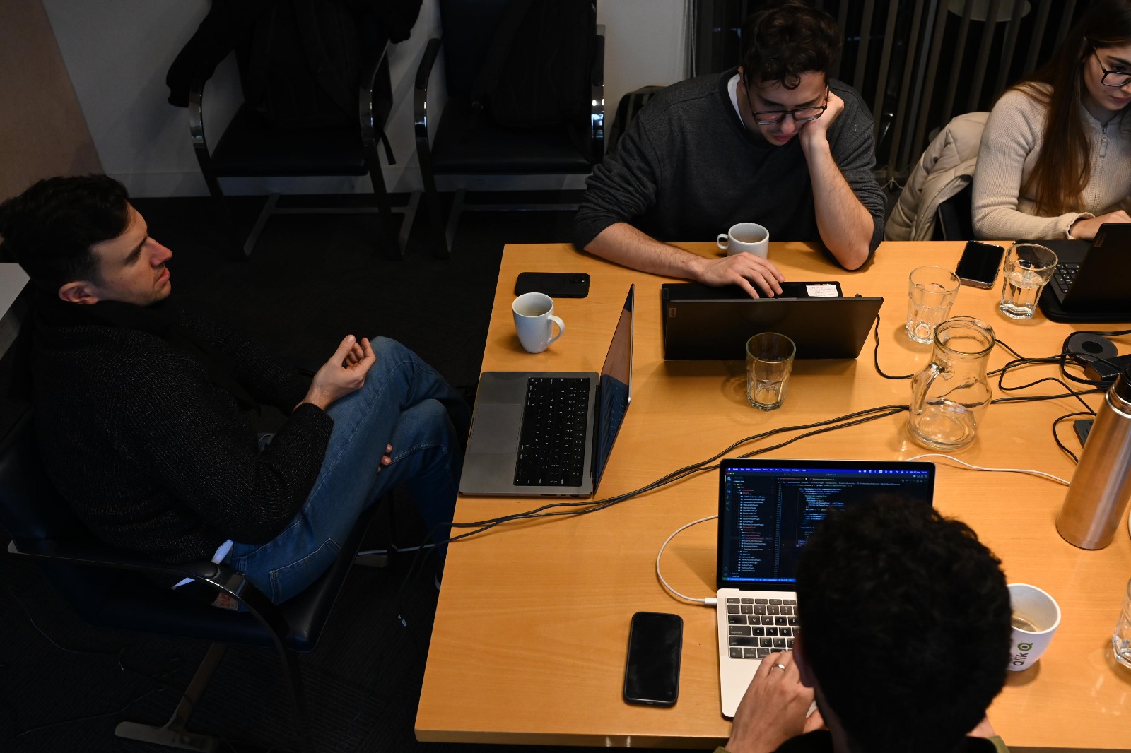 Office workers sitting around a table headed by Ramiro Roballos, Tukki founder